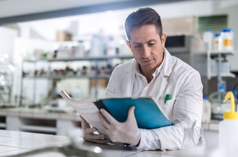 Scientist Reading Catalogue Istock 504611202