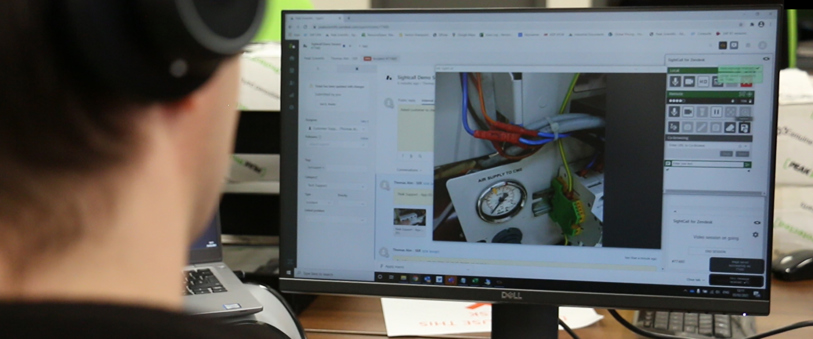 A man looking at a computer helping to fix a gas generator with Visual Support
